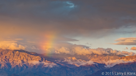 Image of a rainbow at sunrise over Death Valley