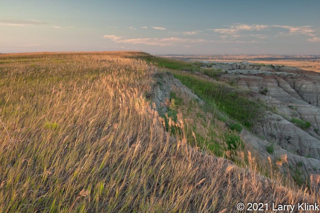 Grassy edge of prarie transitioning to eroded valley.