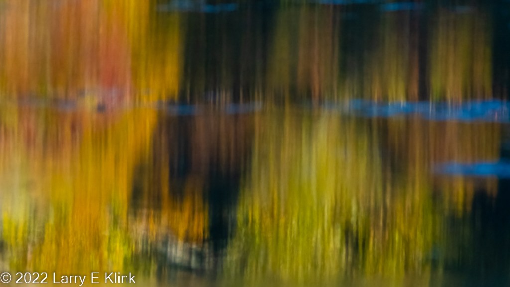 Abstract photographic image of autumn leaves reflected in the waters of the Chattahoochee River.